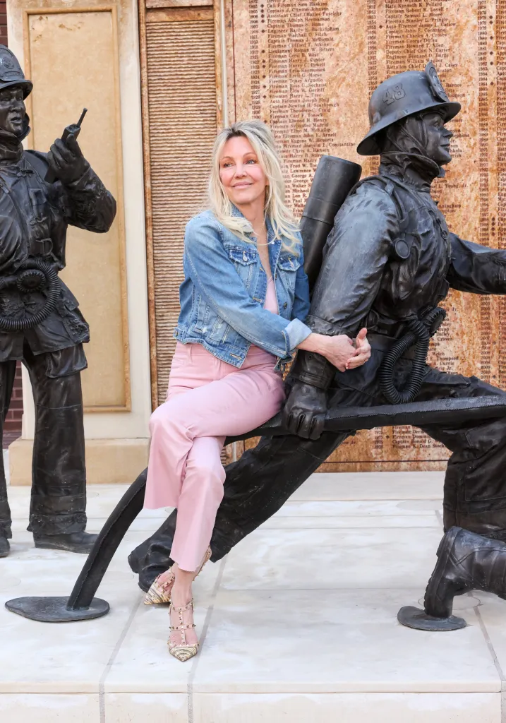 Heather Locklear poses next to a firefighter statue at The Brave & Rescued Awards.