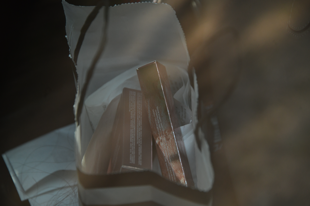 A close-up shot of a white bag containing several packaged products.