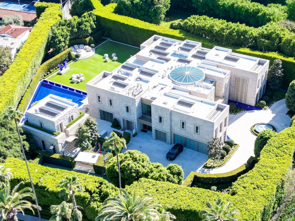 Aerial view of Stephen Cloobeck's Beverly Hills home, featuring a large main house, a guest house, a pool, and manicured hedges.