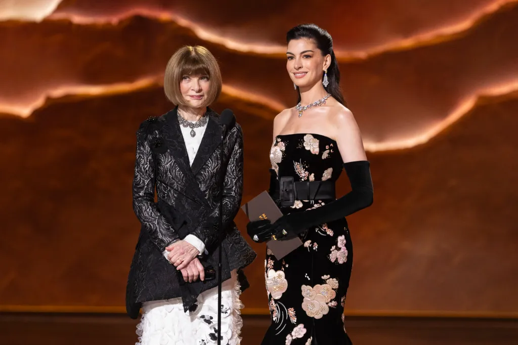 Anna Wintour and Anne Hathaway on stage.