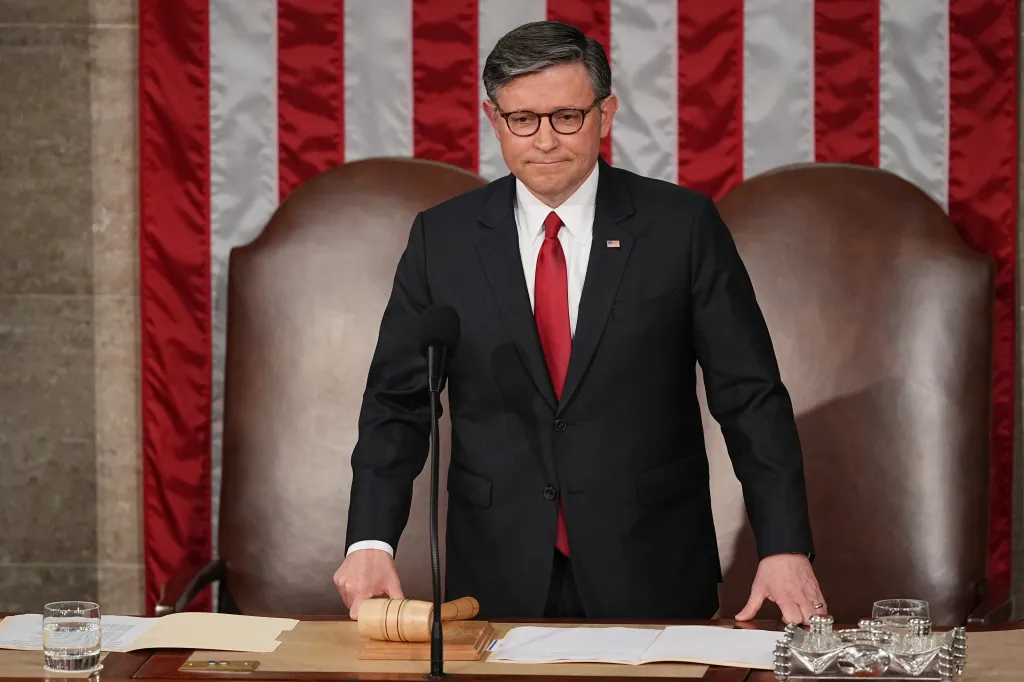 House Speaker Mike Johnson stands at a podium before a joint meeting of Congress.