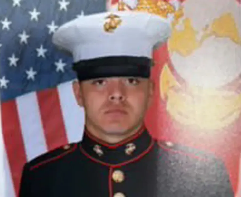 Marine Daniel Montano in uniform with US flag in the background.