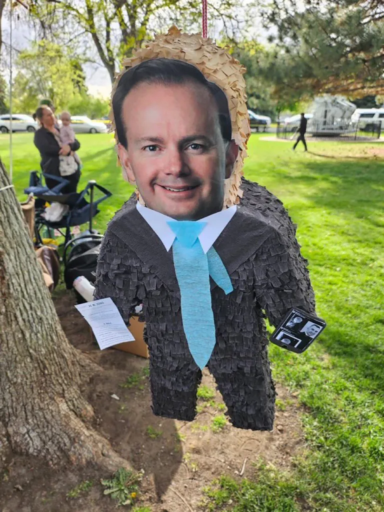 Piñata of Mike Lee dressed in a suit with a light blue tie.