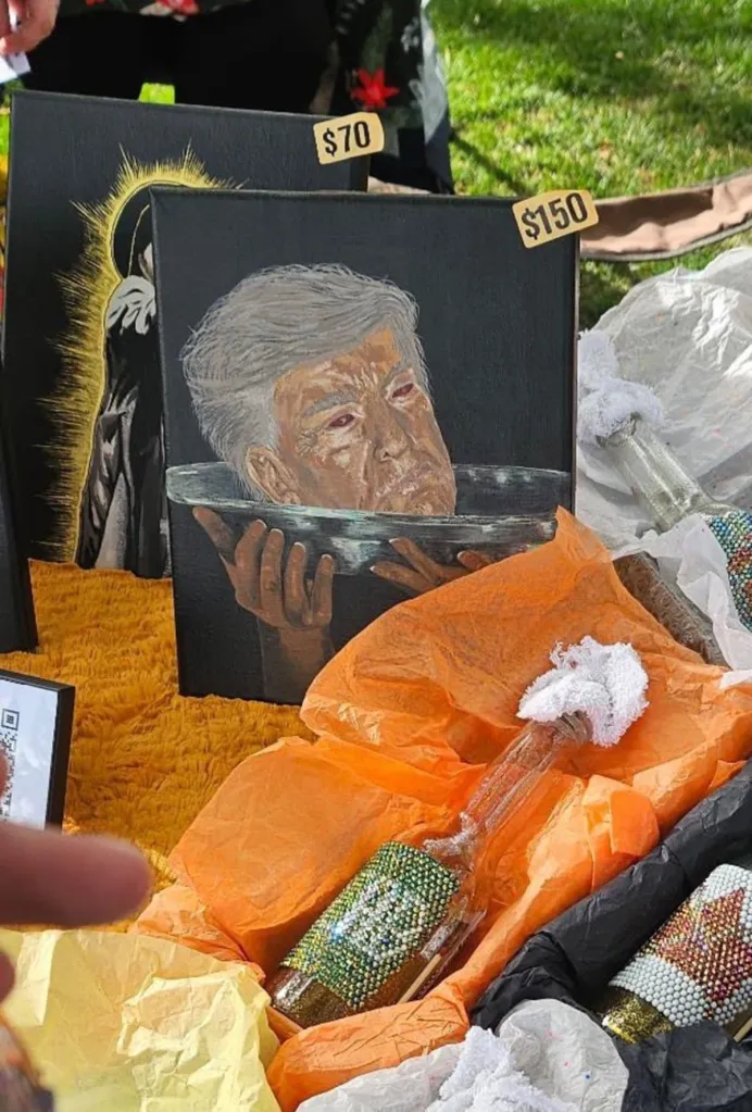 Illustration of a painting of Donald Trump's head in a bowl with bottles wrapped in tissue paper and priced at an art stall.