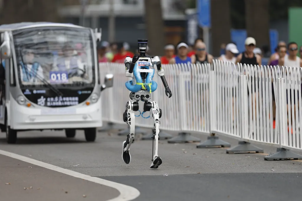 A humanoid robot runs during the Beijing E-Town Half Marathon.