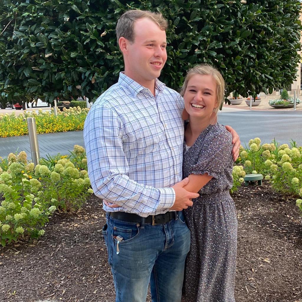 Joseph and Kendra Duggar smiling and embracing outdoors.