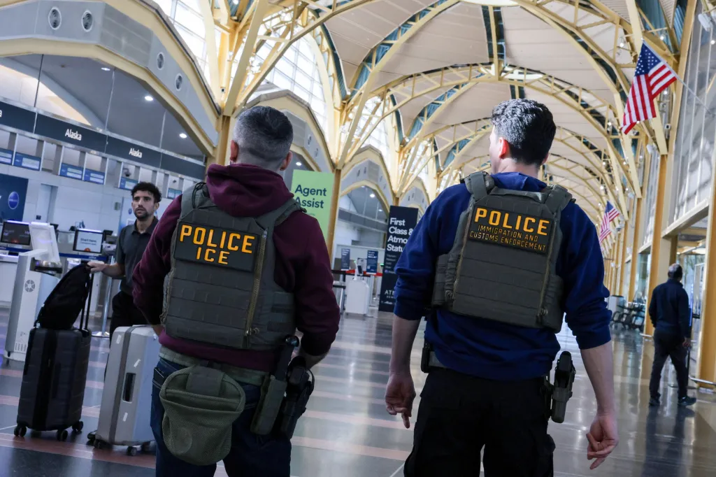 Two ICE agents patrol Washington Reagan National Airport.