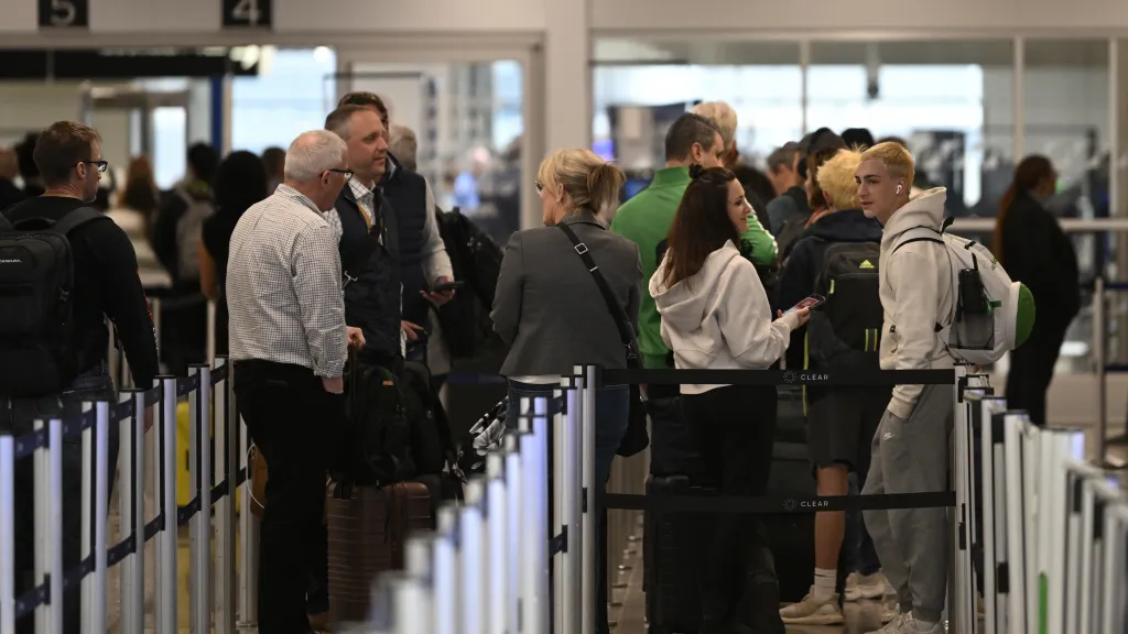 Passengers stand in line at security checkpoints at Hartsfield-Jackson Atlanta International Airport on March 24, 2026.