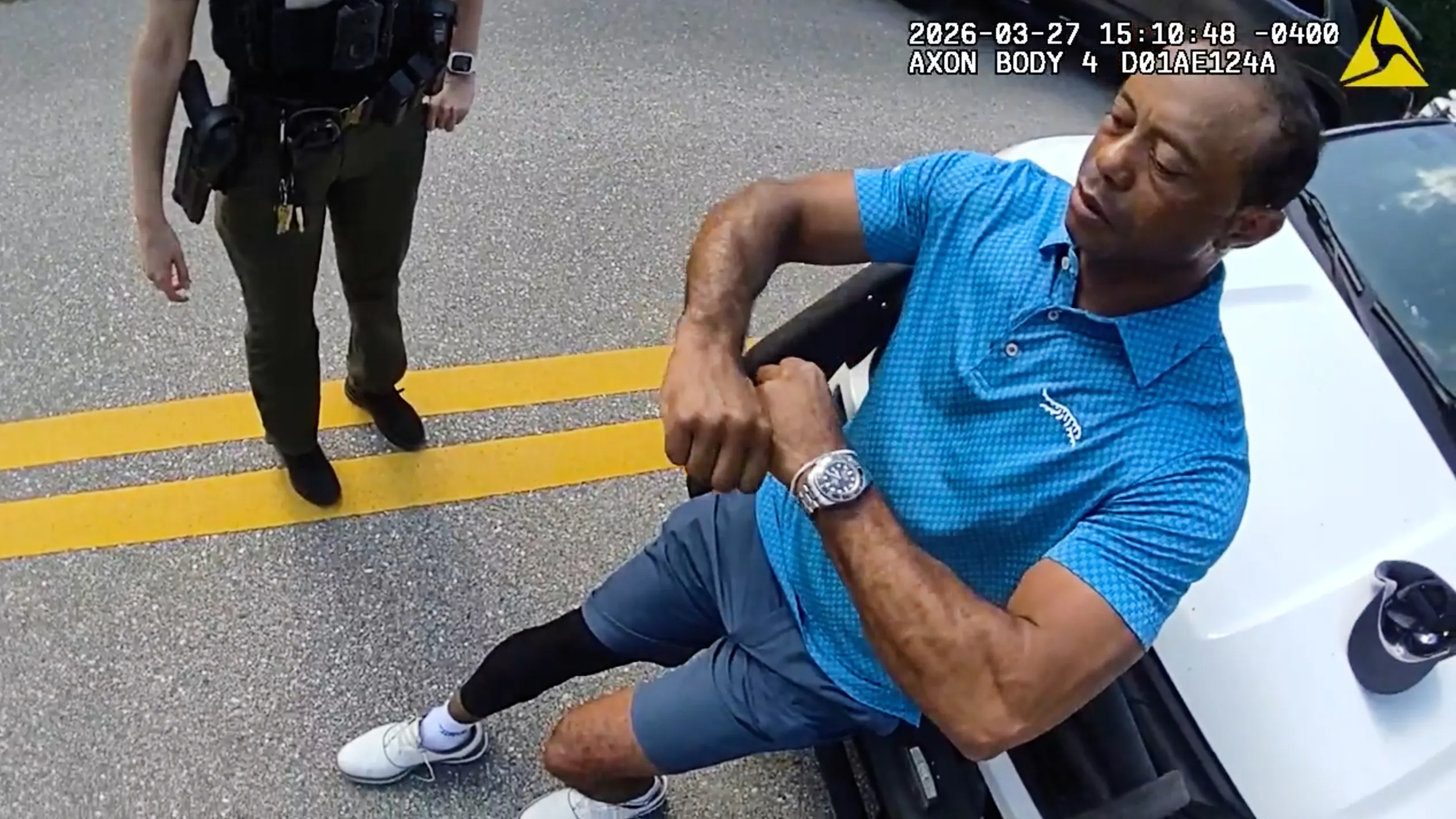Golfer Tiger Woods performing a field sobriety test for sheriff's deputies.