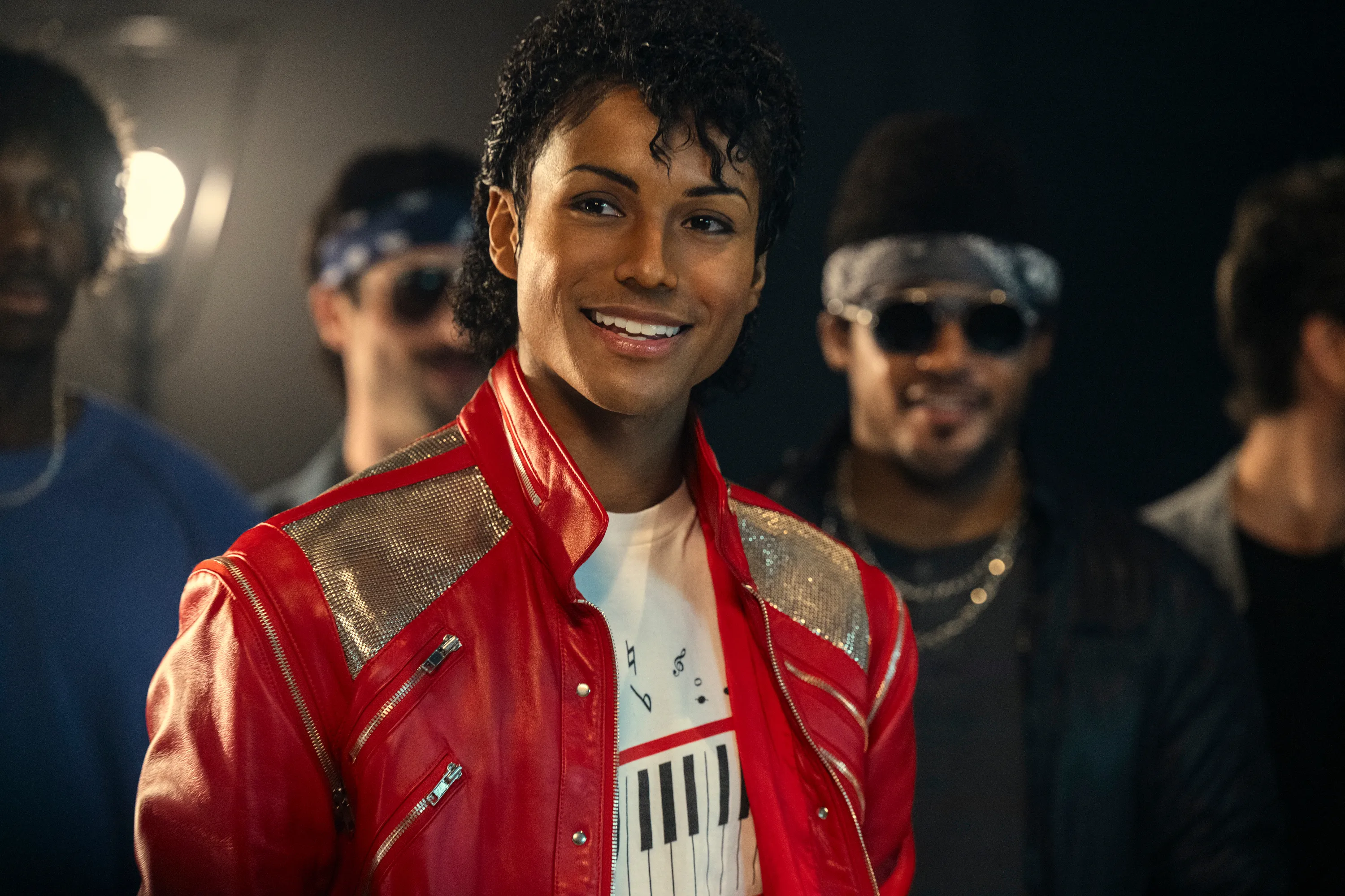 Jaafar Jackson as Michael Jackson in a red jacket.
