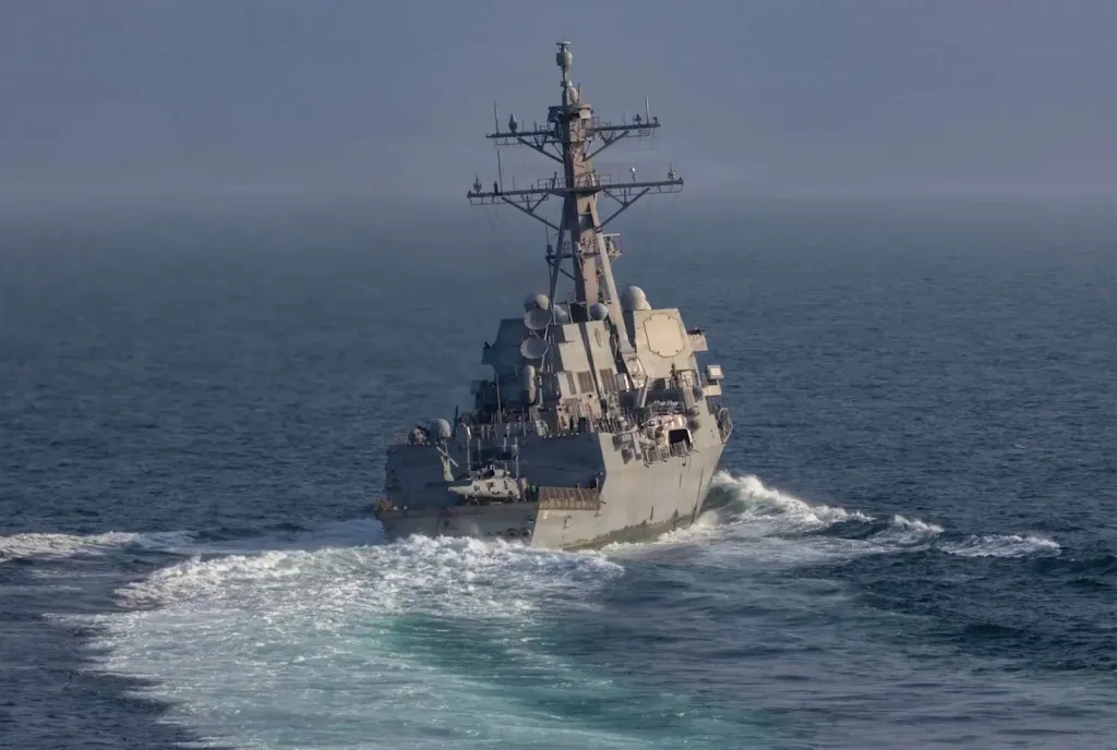 An American naval ship sails through the ocean.