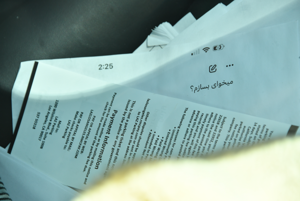 Documents with payment information and what appears to be a parking notice.