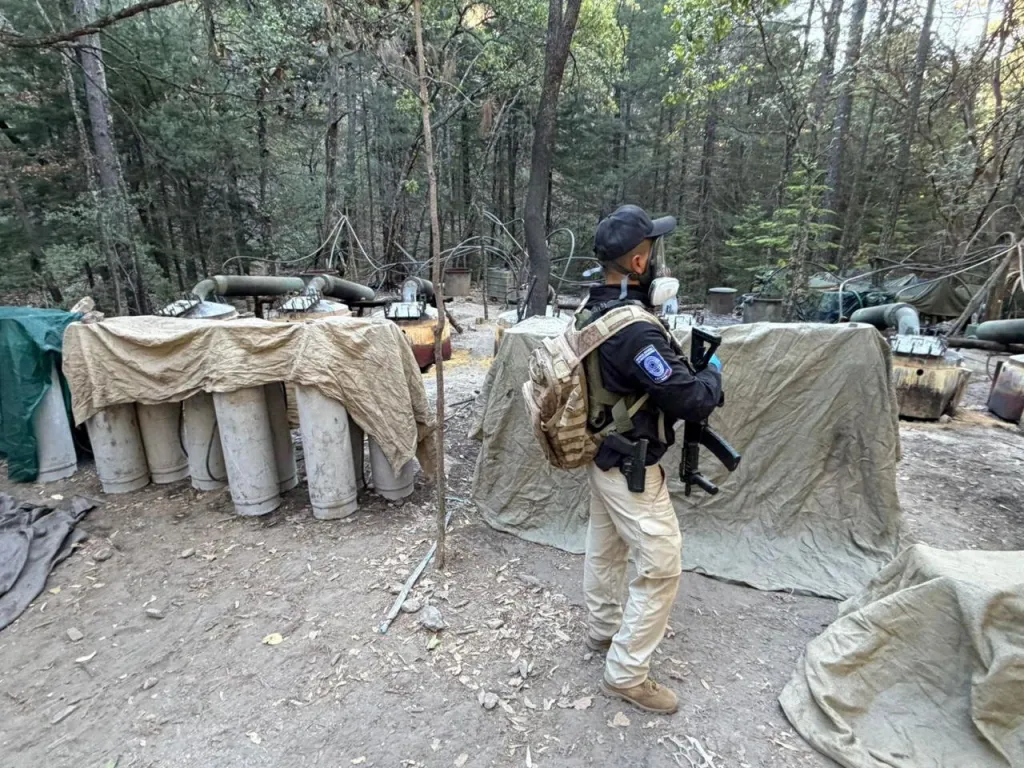 An investigative agent stands inside a clandestine methamphetamine processing laboratory discovered near Guachochi, Mexico.