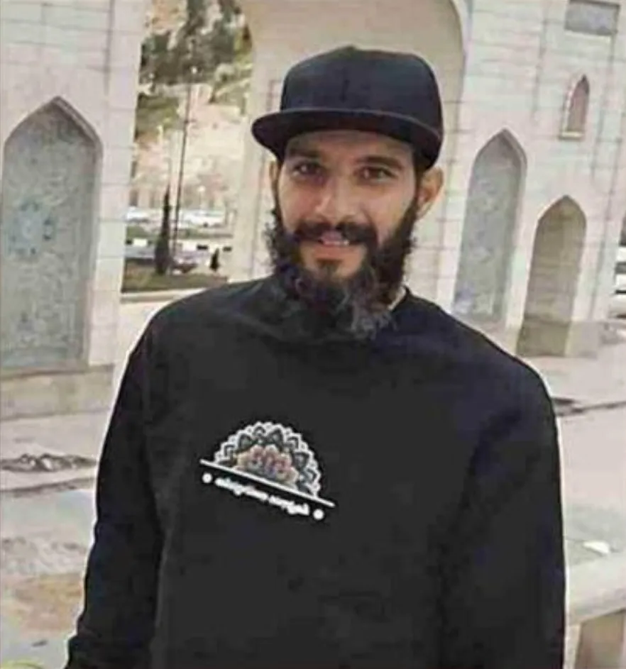 Shahin Vahedparast Kalour wearing a black cap and sweatshirt with a patterned design.