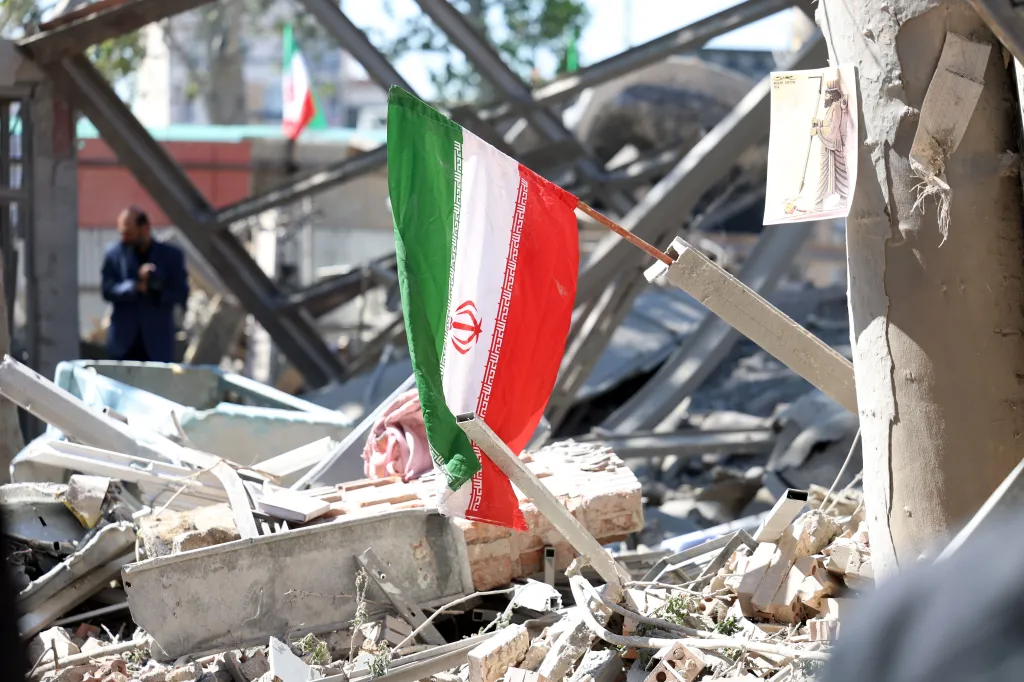 Iranian flag placed on the debris of a damaged building at Sharif University after an airstrike in Tehran.