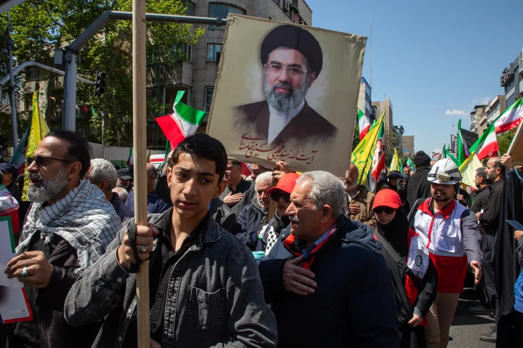 Iranians carry a portrait of Mojtaba Khamenei during a memorial.