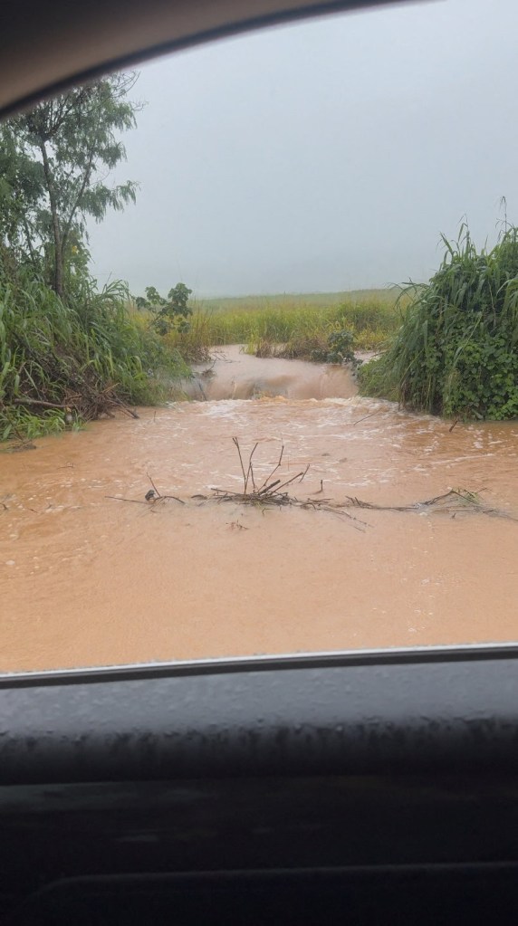 Floodwaters flow onto a street in Oahu, Hawaii, on April 10, 2026.