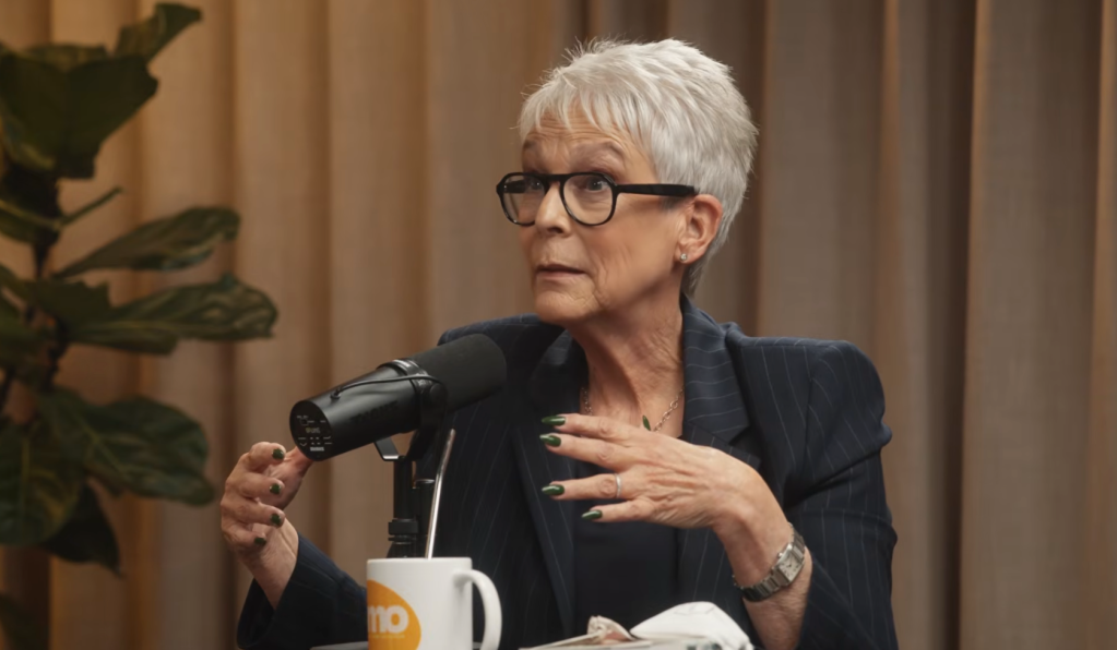 Jamie Lee Curtis speaking into a microphone.