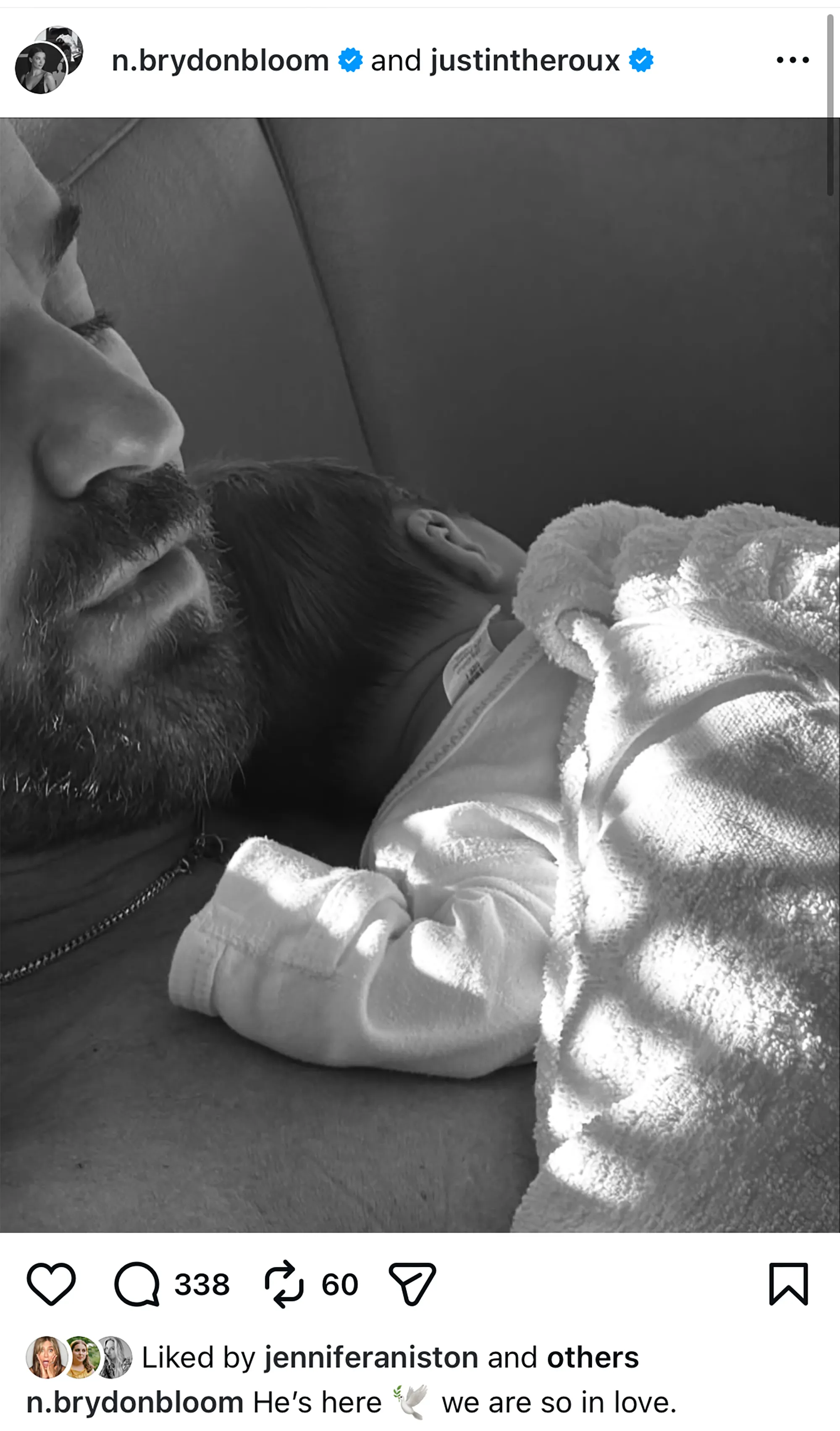 Black and white photo of Justin Theroux with a baby on his chest, an Instagram post liked by Jennifer Aniston.