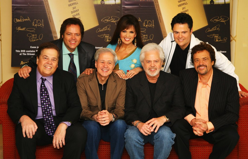 The Osmonds, including Jimmy, Marie, and Donny, pose for a photo promoting their 50th Anniversary Concert.