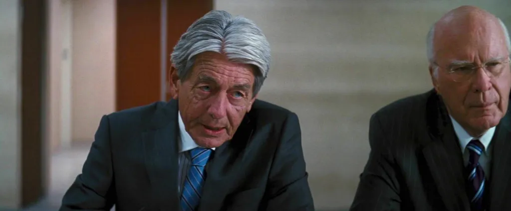 John Nolan and Patrick Leahy in The Dark Knight Rises.