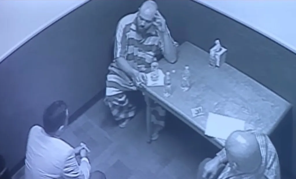 Tanner Horner being interviewed in a prison uniform. 