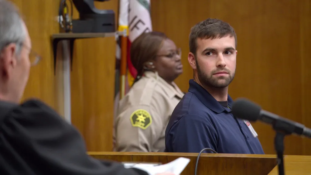 Ronald Gladden as a juror looking towards a judge, with a sheriff's deputy in the background.