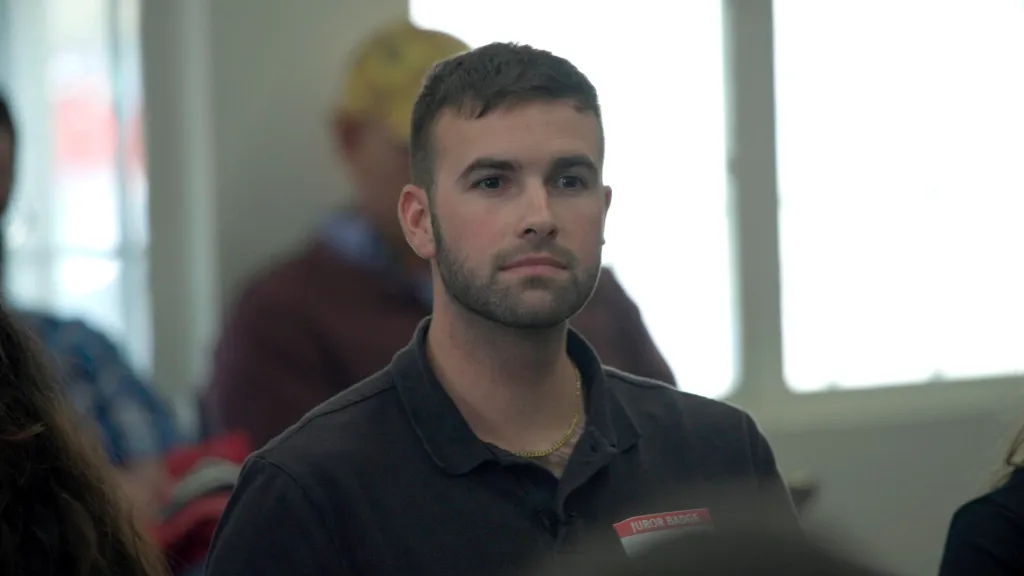 Ronald Gladden, wearing a juror badge.