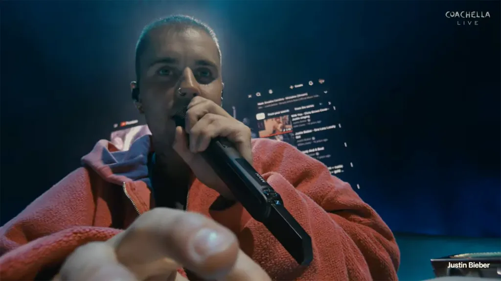 Justin Bieber performing live at Coachella, holding a microphone.