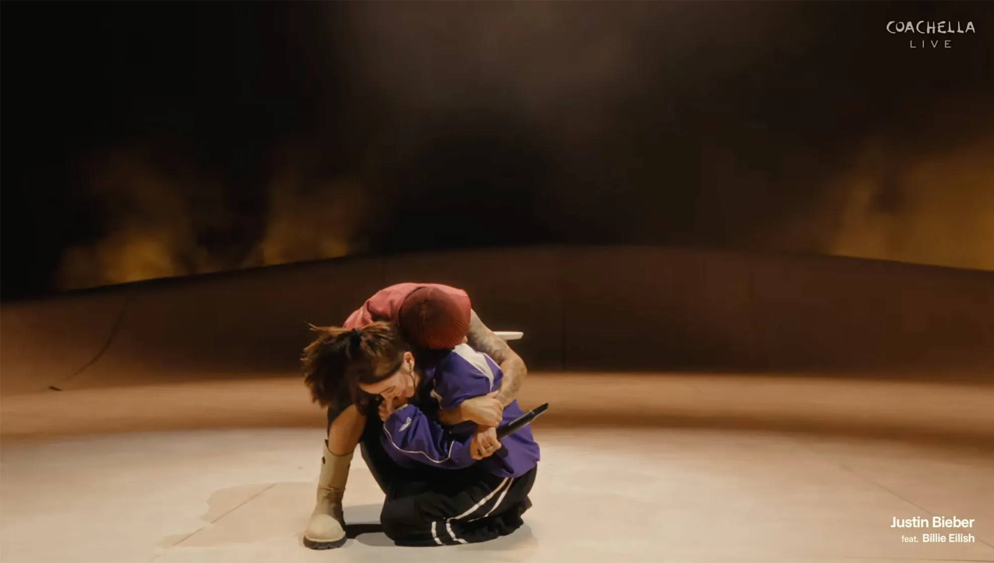 Justin Bieber hugging Billie Eilish on stage during a Coachella performance.