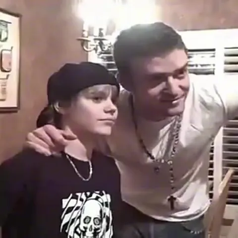 Justin Timberlake with his arm around a young Justin Bieber.