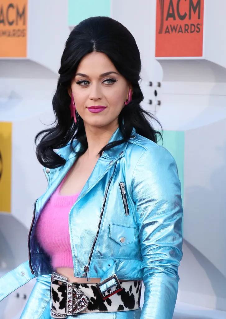 Katy Perry wearing a metallic blue jacket and pink fuzzy top at the 51st Academy of Country Music Awards.