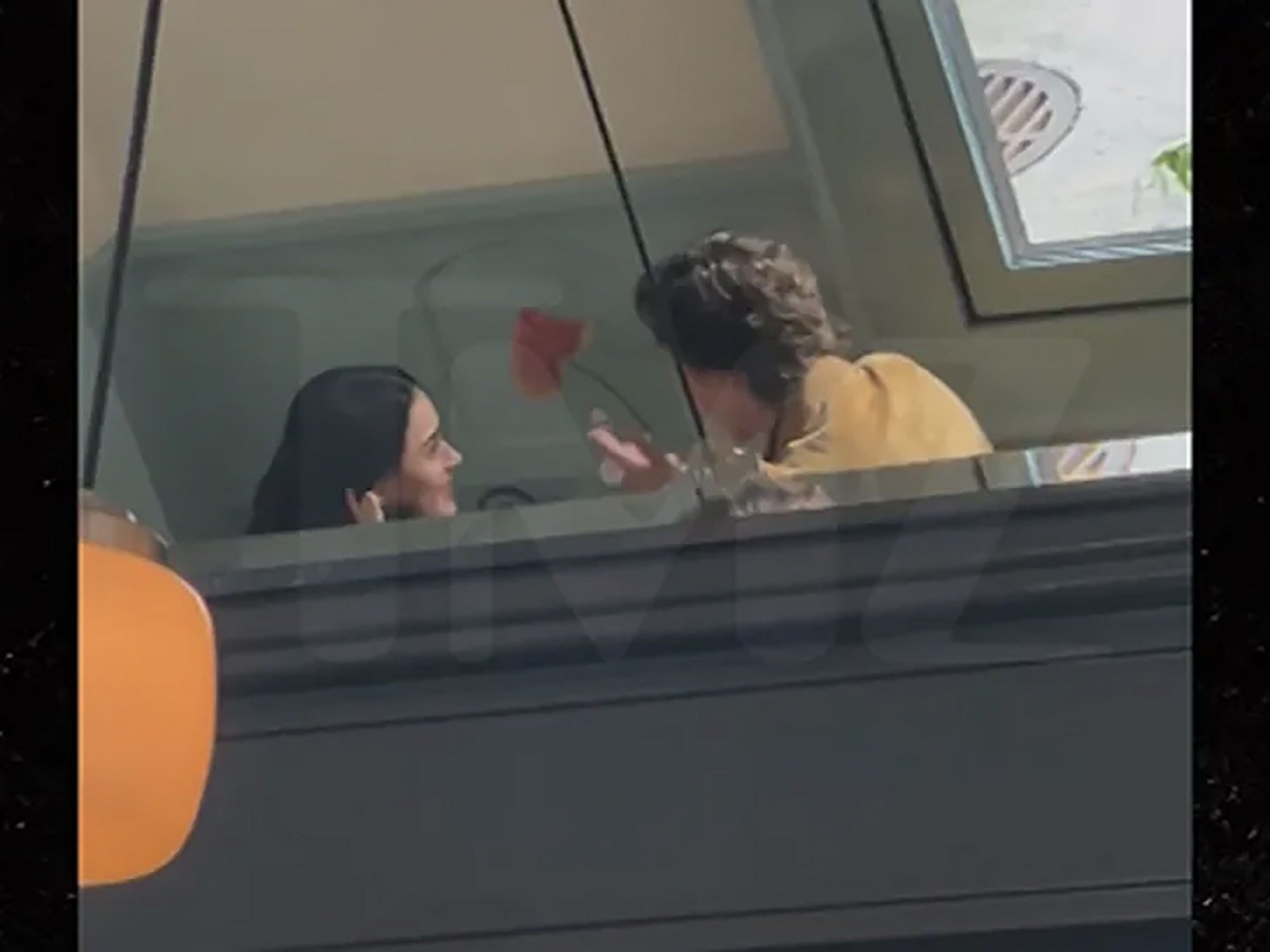 Katy Perry and Justin Trudeau chatting.