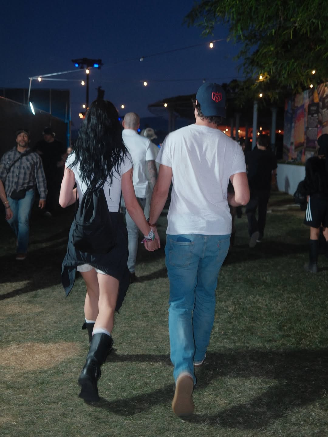 Katy Perry and Justin Trudeau walking at Coachella at night.