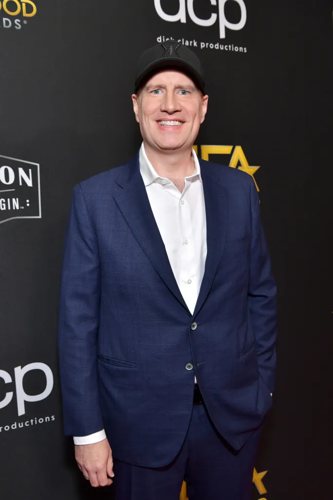Kevin Feige wearing a navy suit and white shirt, with a black baseball cap at the 23rd Annual Hollywood Film Awards.