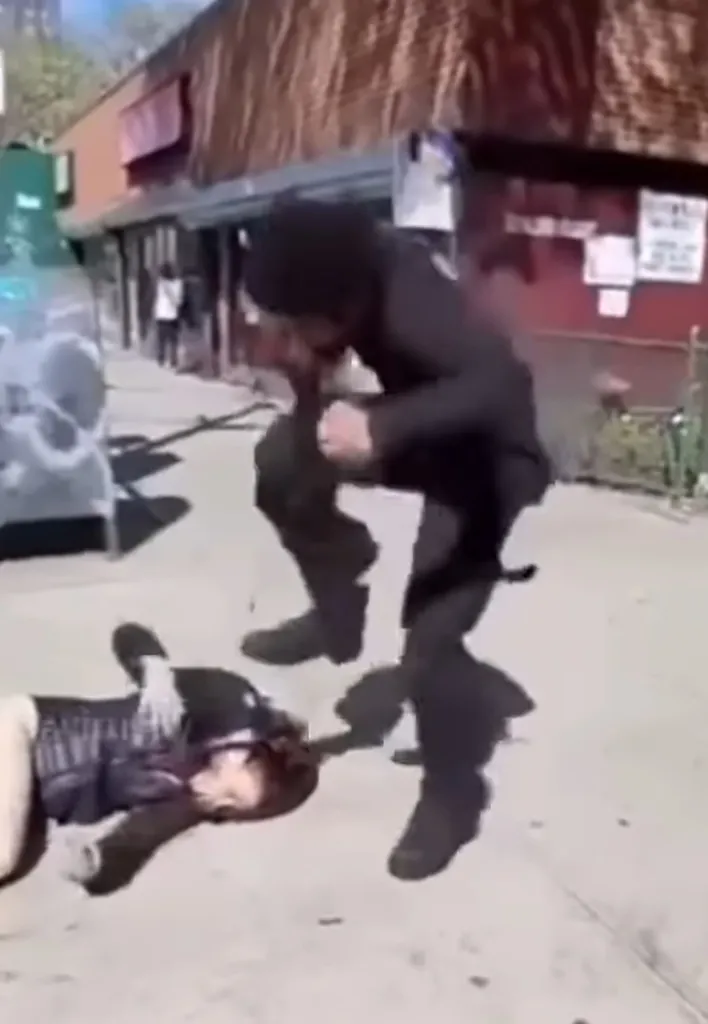 A man stomps on a woman's head as she lies on the ground.