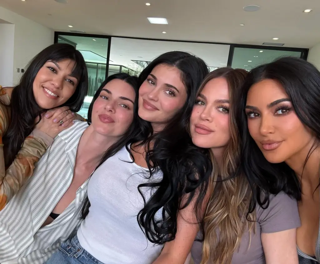 Kourtney, Kendall, Kylie, Khloe, and Kim Kardashian smiling at the camera.