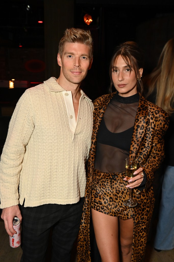 Kyle Cooke and Amanda Batula standing together, looking forward at an event.