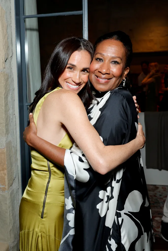 Meghan, Duchess of Sussex, and Nicole Avant embracing and smiling.