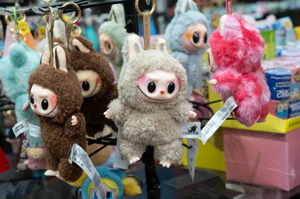 Multiple Labubu dolls on display with attached tags reading 