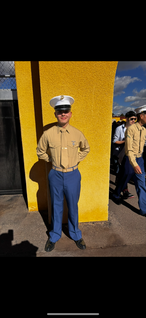 Lance Cpl. Daniel Montano in his Marine uniform, smiling against a yellow wall.