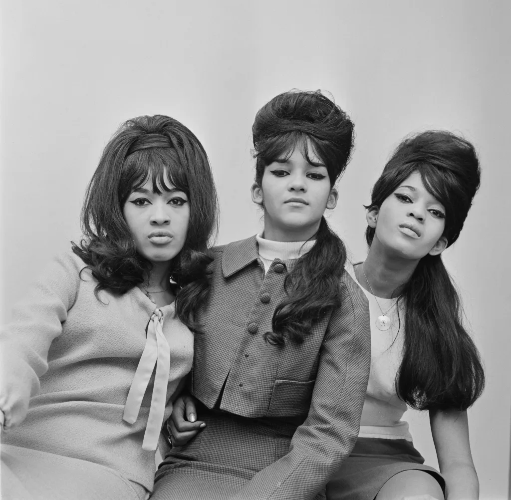 Black and white studio portrait of the American girl group The Ronettes, featuring Veronica Bennett (Ronnie Spector), Nedra Talley, and Estelle Bennett.