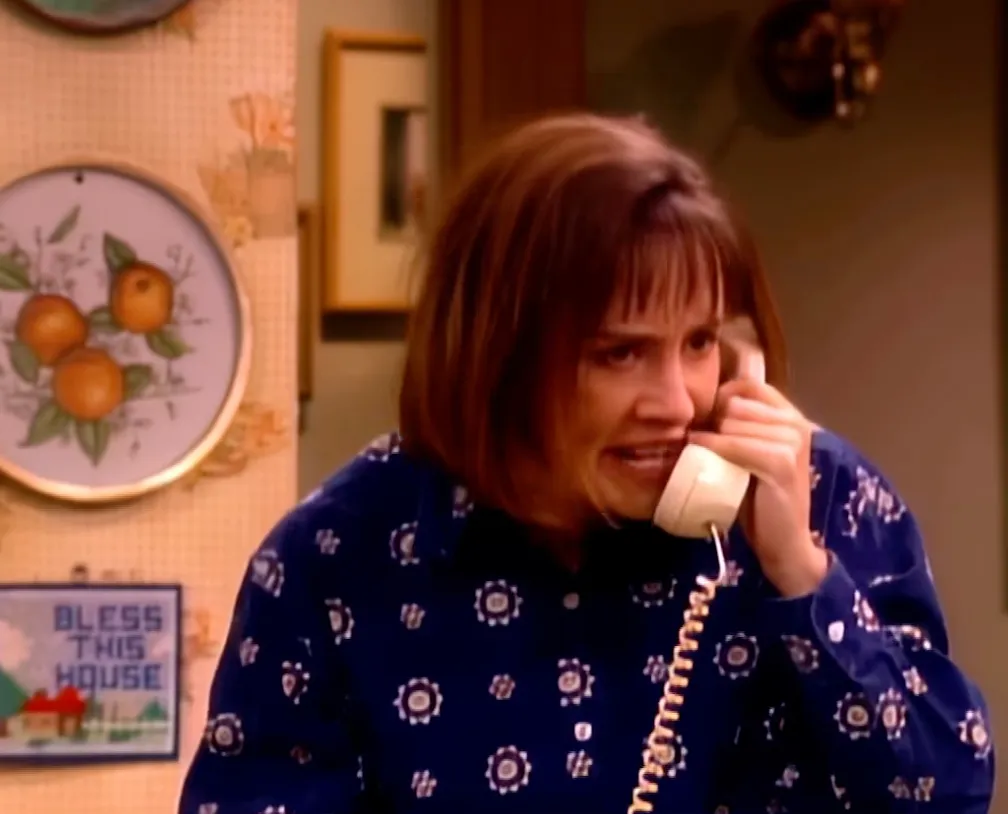 Laurie Metcalf crying on the phone in a scene from Roseanne.