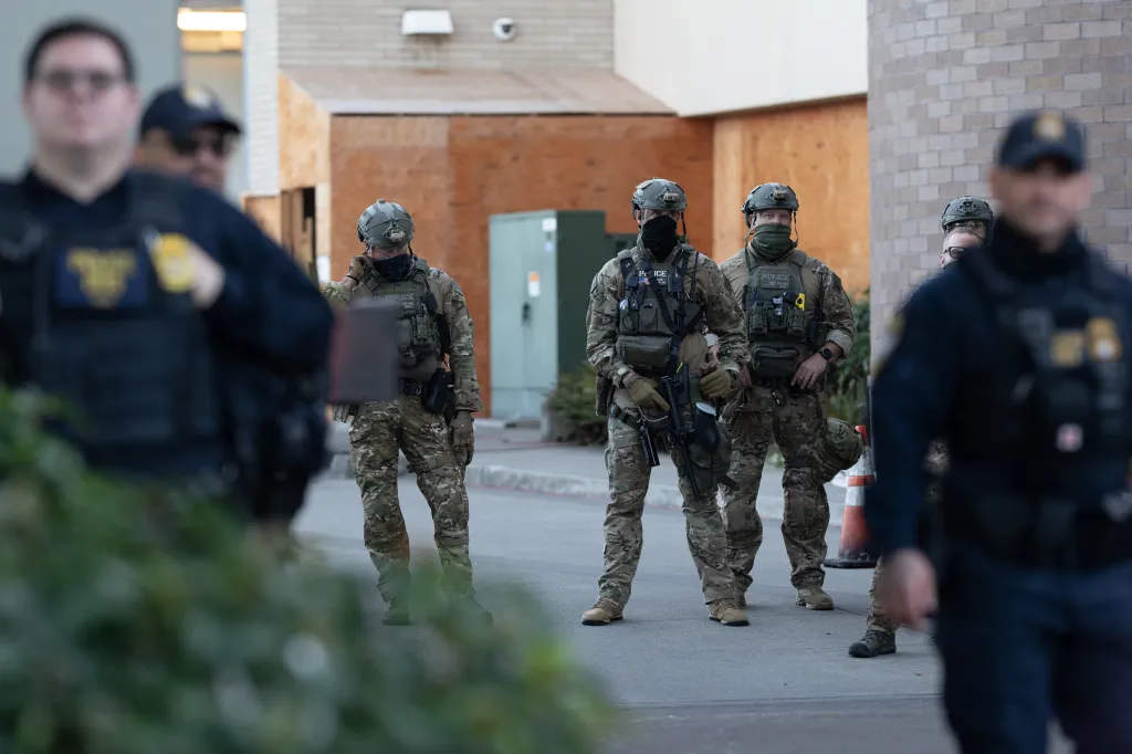 Agents stand guard outside a Immigration and Customs Enforcement facility in Portland, Oregon, on Oct, 21, 2025.