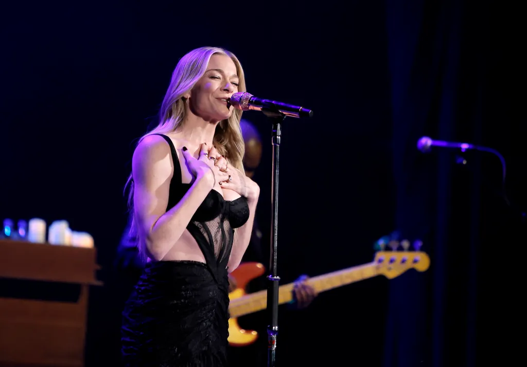 LeAnn Rimes sings into a microphone during her Greatest Hits Christmas Tour.