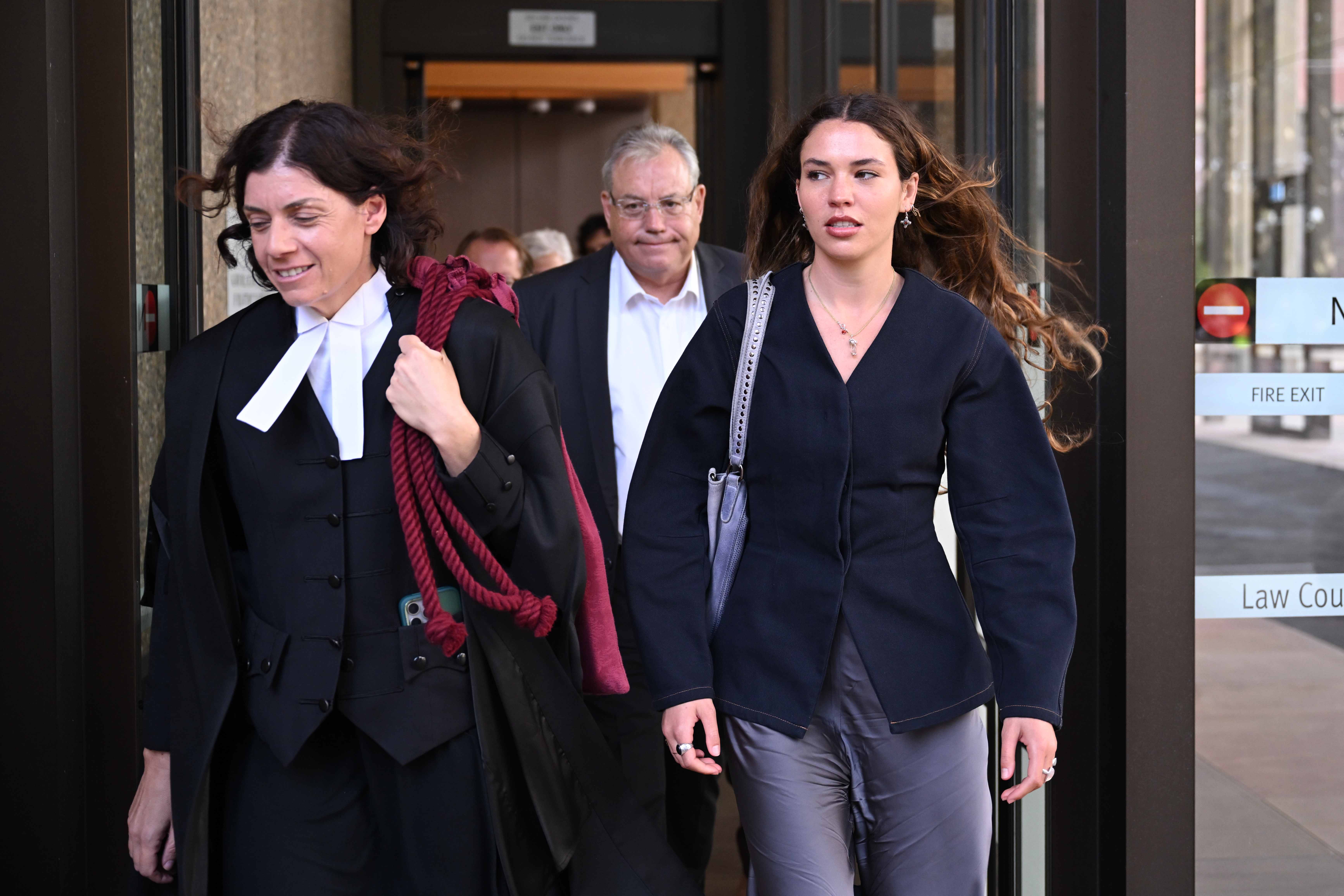 Charlotte MacInnes (right) leaves the Federal Court of Australia.