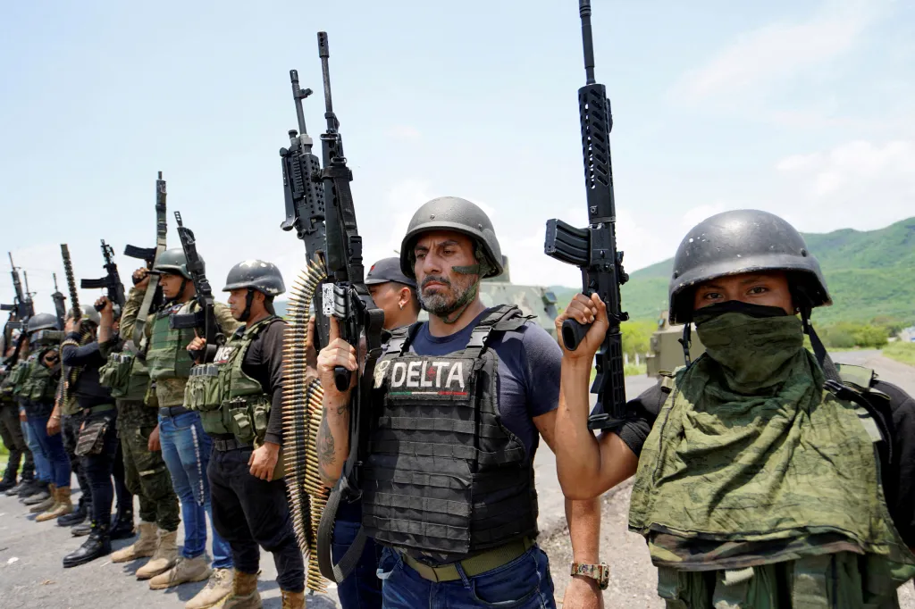 Members of the Jalisco New Generation Cartel (CJNG), led by Nemesio Oseguera, known as El Mencho, pose for a photo at an undisclosed location in Michoacan state, Mexico, July 1, 2021.