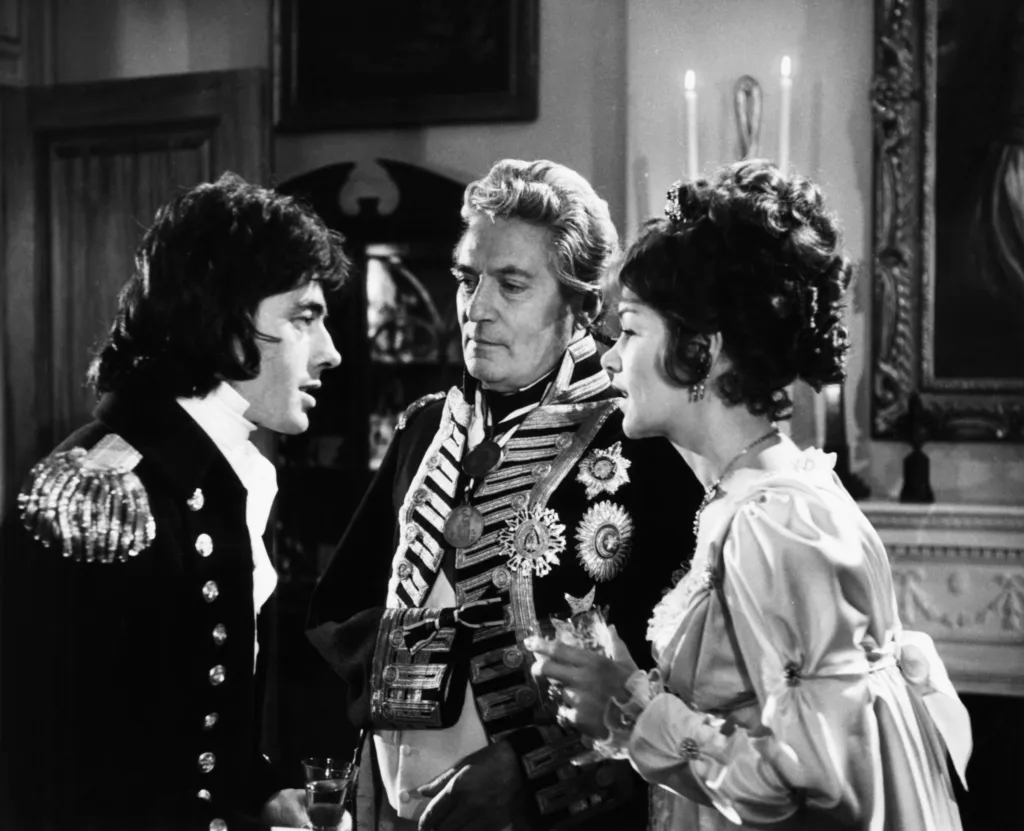 John Nolan, Peter Finch, and Glenda Jackson in a scene from 