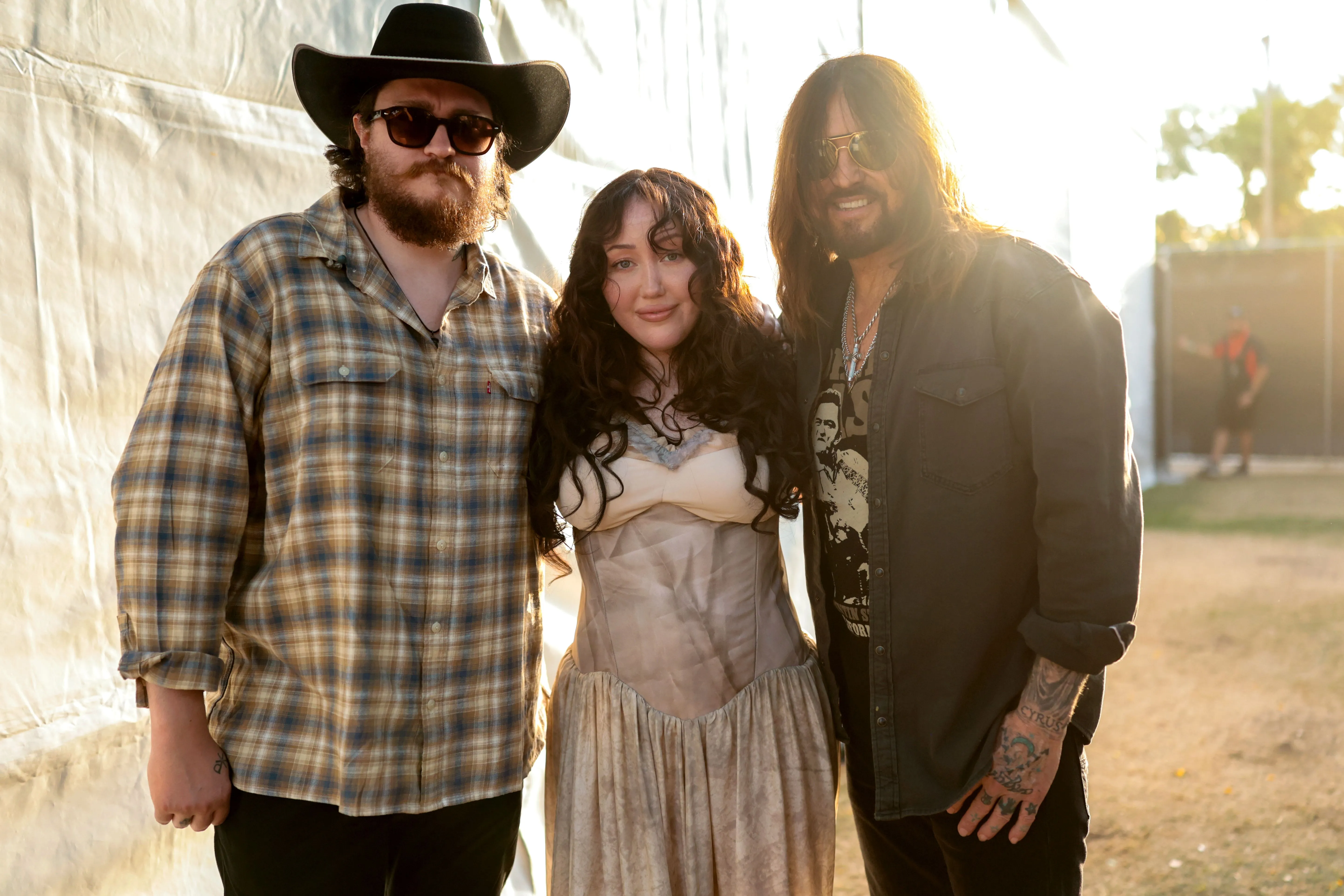Braison Cyrus, Noah Cyrus, and Billy Ray Cyrus posing for a portrait backstage at the Stagecoach Festival.