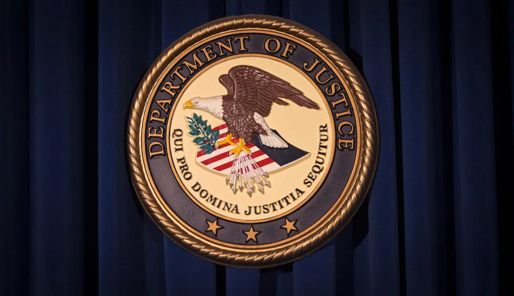 The Department of Justice logo, featuring an eagle and the words 